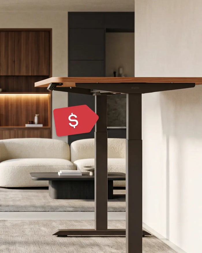 A brown wooden standing desk with black legs sits in a modern living room.